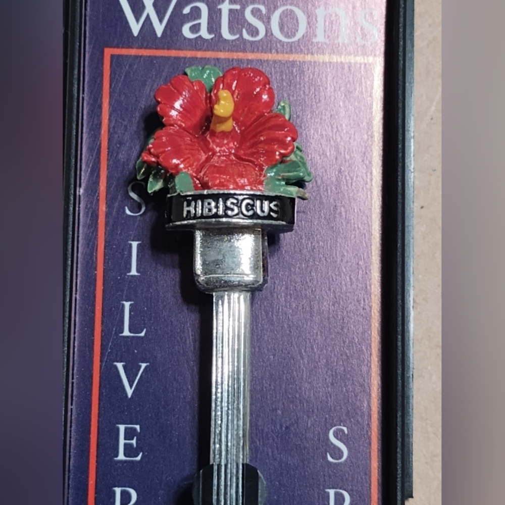 Watsons brand silver plated spoon with hibiscus design. New in box